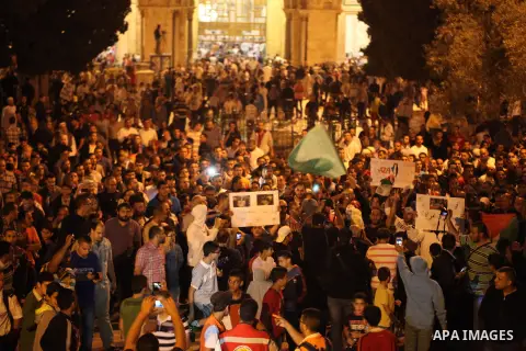 Palestinians shout slogans during a protest in front of the Dome of the Rock at the Al-Aqsa Mosque compound in the Old City of Jerusalem on July 20, 2014, in protest against Israel's military operation in the Gaza Strip....