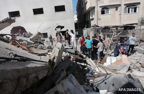 Palestinian rescuers search for bodies and survivors in the rubble of homes which were destroyed by an Israeli missile strike, in Gaza City, Monday, July 21, 2014. On Sunday, the first major ground battle in two weeks of...