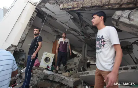 Palestinian rescuers search for bodies and survivors in the rubble of homes which were destroyed by an Israeli missile strike, in Gaza City, Monday, July 21, 2014. On Sunday, the first major ground battle in two weeks of...