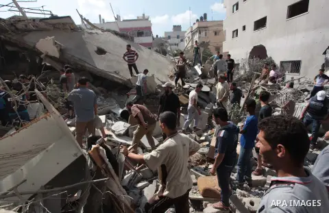 Palestinian rescuers search for bodies and survivors in the rubble of homes which were destroyed by an Israeli missile strike, in Gaza City, Monday, July 21, 2014. On Sunday, the first major ground battle in two weeks of...