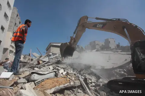 Palestinian rescue workers search for survivors under the rubble of a house was destroyed by an Israeli missile strike, in Gaza City, Monday, July 21, 2014. On Sunday, the first major ground battle in two weeks of Israel...
