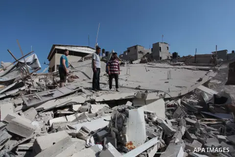 Palestinian rescuers search for bodies and survivors in the rubble of homes which were destroyed by an Israeli missile strike, in Gaza City, Monday, July 21, 2014. On Sunday, the first major ground battle in two weeks of...