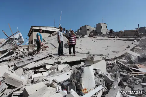 Palestinian rescuers search for bodies and survivors in the rubble of homes which were destroyed by an Israeli missile strike, in Gaza City, Monday, July 21, 2014. On Sunday, the first major ground battle in two weeks of...