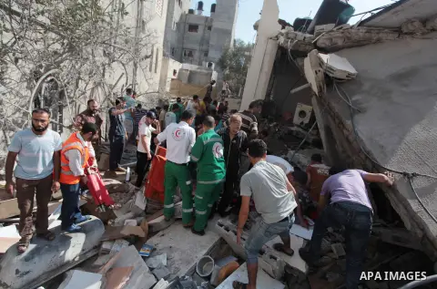 Palestinian rescuers search for bodies and survivors in the rubble of homes which were destroyed by an Israeli missile strike, in Gaza City, Monday, July 21, 2014. On Sunday, the first major ground battle in two weeks of...