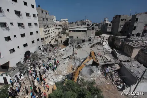 Palestinian rescue workers search for survivors under the rubble of a house was destroyed by an Israeli missile strike, in Gaza City, Monday, July 21, 2014. On Sunday, the first major ground battle in two weeks of Israel...