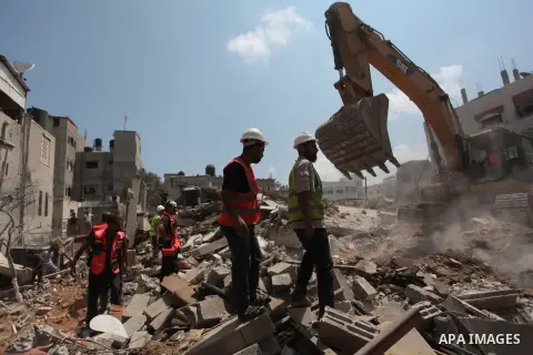 Palestinian rescue workers search for survivors under the rubble of a house was destroyed by an Israeli missile strike, in Gaza City, Monday, July 21, 2014. On Sunday, the first major ground battle in two weeks of Israel...