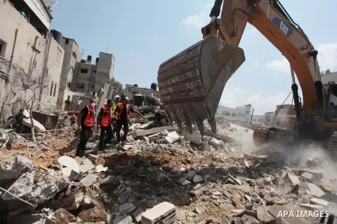 Palestinian rescue workers search for survivors under the rubble of a house was destroyed by an Israeli missile strike, in Gaza City, Monday, July 21, 2014. On Sunday, the first major ground battle in two weeks of Israel...