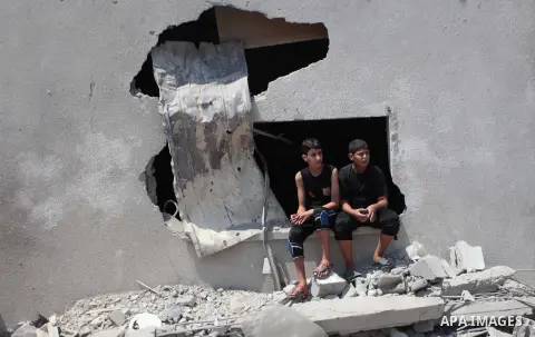 Palestinian rescue workers search for survivors under the rubble of a house was destroyed by an Israeli missile strike, in Gaza City, Monday, July 21, 2014. On Sunday, the first major ground battle in two weeks of Israel...