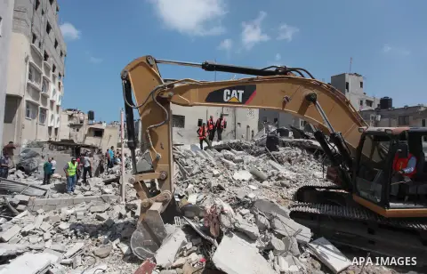 Palestinian rescue workers search for survivors under the rubble of a house was destroyed by an Israeli missile strike, in Gaza City, Monday, July 21, 2014. On Sunday, the first major ground battle in two weeks of Israel...