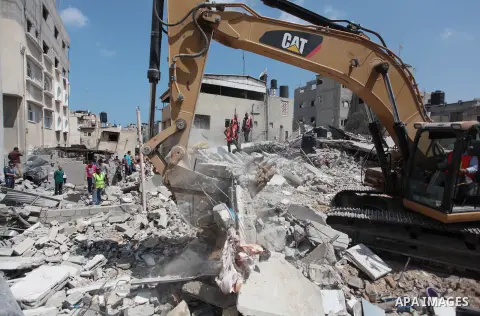 Palestinian rescue workers search for survivors under the rubble of a house was destroyed by an Israeli missile strike, in Gaza City, Monday, July 21, 2014. On Sunday, the first major ground battle in two weeks of Israel...