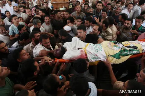 Palestinian mourners carry bodies of members Abu Jamaa family during the funeral for those killed in a three-storey house belonging to the Abu Jamaa family the day before following heavy Israeli bombardment, in Khan Yuni...
