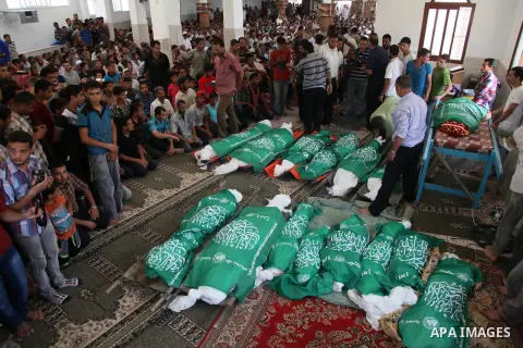 Palestinian mourners pray in a mosque during the funeral for those killed in a three-storey house belonging to the Abu Jamaa family the day before following heavy Israeli bombardment, in Khan Yunis, in the southern Gaza...