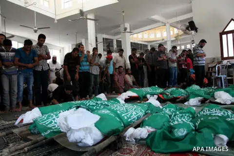 Palestinian mourners pray in a mosque during the funeral for those killed in a three-storey house belonging to the Abu Jamaa family the day before following heavy Israeli bombardment, in Khan Yunis, in the southern Gaza...