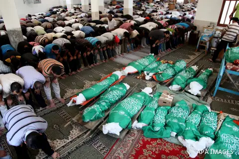 Palestinian mourners pray in a mosque during the funeral for those killed in a three-storey house belonging to the Abu Jamaa family the day before following heavy Israeli bombardment, in Khan Yunis, in the southern Gaza...