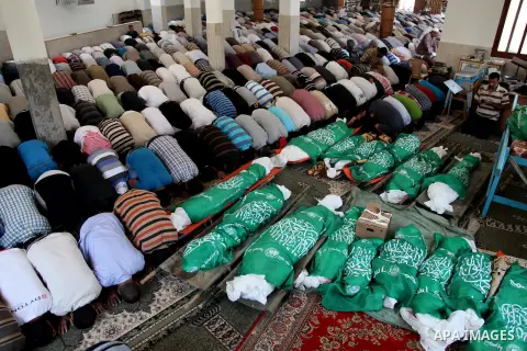 Palestinian mourners pray in a mosque during the funeral for those killed in a three-storey house belonging to the Abu Jamaa family the day before following heavy Israeli bombardment, in Khan Yunis, in the southern Gaza...