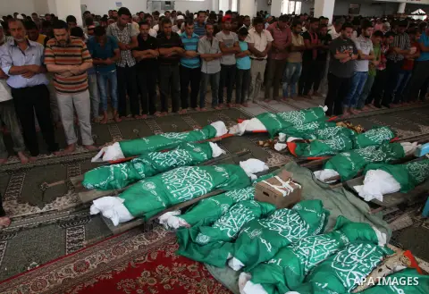 Palestinian mourners pray in a mosque during the funeral for those killed in a three-storey house belonging to the Abu Jamaa family the day before following heavy Israeli bombardment, in Khan Yunis, in the southern Gaza...