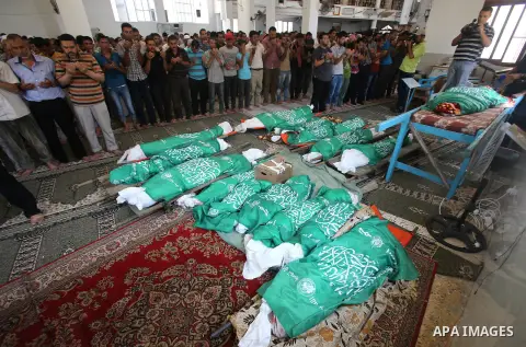 Palestinian mourners pray in a mosque during the funeral for those killed in a three-storey house belonging to the Abu Jamaa family the day before following heavy Israeli bombardment, in Khan Yunis, in the southern Gaza...