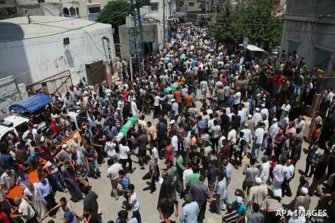 Palestinian mourners carry bodies of members Abu Jamaa family during the funeral for those killed in a three-storey house belonging to the Abu Jamaa family the day before following heavy Israeli bombardment, in Khan Yuni...