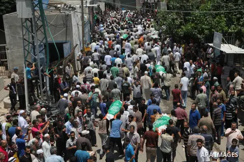 Palestinian mourners carry bodies of members Abu Jamaa family during the funeral for those killed in a three-storey house belonging to the Abu Jamaa family the day before following heavy Israeli bombardment, in Khan Yuni...