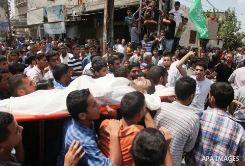 Palestinian mourners carry bodies of members Abu Jamaa family during the funeral for those killed in a three-storey house belonging to the Abu Jamaa family the day before following heavy Israeli bombardment, in Khan Yuni...