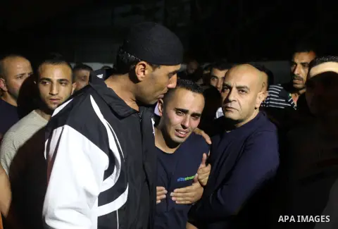 Palestinian relatives mourn the death of Mahmoud Shawamreh, 22, at a hospital in the West Bank City of Ramallah July 21, 2014. An Israeli shot dead a Palestinian who had been throwing stones at his car north of Jerusalem...