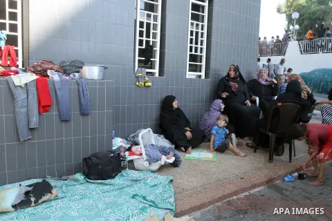 Displaced Palestinians wait at al-Shifa hospital where they have taken refuge after fleeing heavy fighting in their area, in Gaza City on July 21, 2014. The Palestinian death toll in an Israeli offensive in the Gaza Stri...