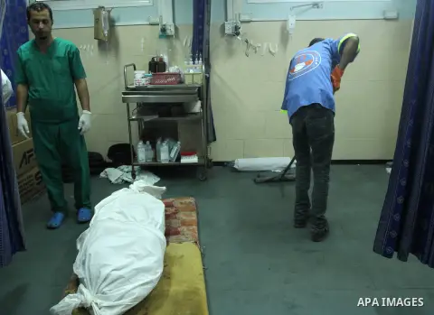 The body of a Palestinian man, who medics said was killed by Israeli shelling, lies at al-Shifa hospital morgue in Gaza City on July 21, 2014. The Palestinian death toll in an Israeli offensive in the Gaza Strip jumped t...