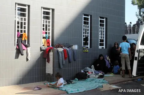 Displaced Palestinians wait at al-Shifa hospital where they have taken refuge after fleeing heavy fighting in their area, in Gaza City on July 21, 2014. The Palestinian death toll in an Israeli offensive in the Gaza Stri...