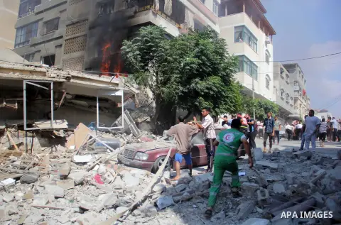 Palestinians inspect a destroyed building following an Israeli air strike at al-Shatee refugee camp, in Gaza City on July 21, 2014. The Palestinian death toll in an Israeli offensive in the Gaza Strip jumped to more than...