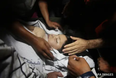 Relatives mourn the death of one Palestinian children from the Baker family, who was Injury by a shell fired by an Israeli naval gunboat, at the beach in Gaza Strip on July 16, 2014, Gaza City on July 22, 2014. Israel ke...