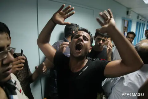 Relatives mourn the death of one Palestinian children from the Baker family, who was Injury by a shell fired by an Israeli naval gunboat, at the beach in Gaza Strip on July 16, 2014, Gaza City on July 22, 2014. Israel ke...