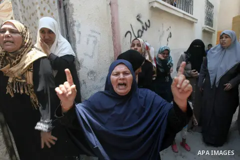 Palestinian female mourners grieve during the funeral of Mohammed al-Hamaida after he was killed in an Israeli air strike, on July 22, 2014, in Rafah town in the southern Gaza Strip. A series of Israeli air strikes early...