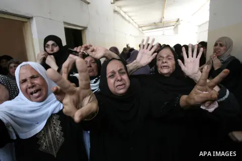Palestinian female mourners grieve during the funeral of Mohammed al-Hamaida after he was killed in an Israeli air strike, on July 22, 2014, in Rafah town in the southern Gaza Strip. A series of Israeli air strikes early...