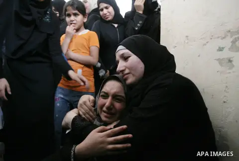 Palestinian female mourners grieve during the funeral of Mohammed al-Hamaida after he was killed in an Israeli air strike, on July 22, 2014, in Rafah town in the southern Gaza Strip. A series of Israeli air strikes early...