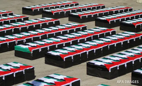 Symbolic coffins are seen during a protest in solidarity with Palestinians killed by Israeli forces in Gaza Strip, in the West Bank City of Ramallah on July 22, 2014. A series of Israeli air strikes early killed seven pe...