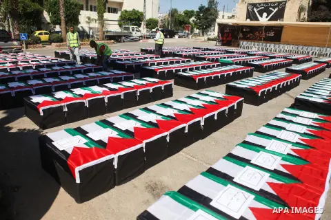 Palestinians prepare symbolic coffins during a protest in solidarity with Palestinians killed by Israeli forces in Gaza Strip, in the West Bank City of Ramallah on July 22, 2014. A series of Israeli air strikes early kil...