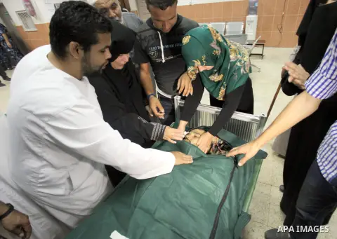 Palestinian relatives mourn over the body of Haitham El-Agha, who medics said was killed in an Israeli air strike, at a hospital in Khan Younis in the southers Gaza Strip July 22, 2014. A series of Israeli air strikes ea...