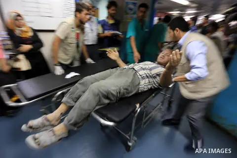 Palestinian man, who medics said was wounded by Israeli shelling, brought to a hospital in Gaza City July 23, 2014. Israeli forces pounded multiple sites across the Gaza Strip on Wednesday, including the enclave's sole p...