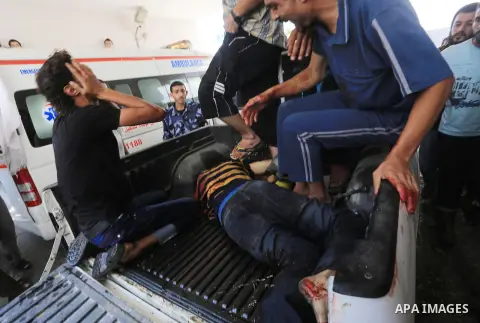 A dead Palestinian Man,, is brought to al-shifa hospital in Gaza City, follwoing an Israeli air strike on July 23, 2014. Eleven women and children were among 17 Palestinians killed in Israeli strikes on Gaza, hiking the...