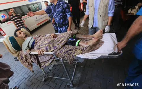 Palestinian man, who medics said was wounded by Israeli shelling, brought to a hospital in Gaza City July 23, 2014. Israeli forces pounded multiple sites across the Gaza Strip on Wednesday, including the enclave's sole p...