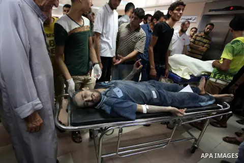 Palestinian man, who medics said was wounded by Israeli shelling, brought to Al-Shifa hospital in Gaza City July 23, 2014. Israeli forces pounded multiple sites across the Gaza Strip on Wednesday, including the enclave's...