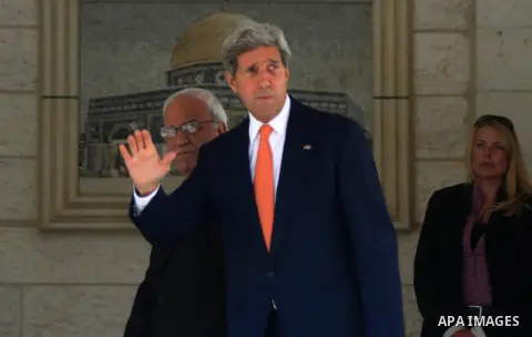 U.S. Secretary of State John Kerry, right, and chief Palestinian negotiator Saeb Erekat arrive at a meeting with Palestinian President Mahmoud Abbas in the West Bank city of Ramallah, Wednesday, July 23, 2014. Kerry is m...