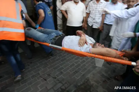 A Palestinian man, who medics said was wounded in Israeli shelling, arrives at a hospital in Khan Younis in the southern Gaza Strip July 23, 2014. Israeli forces pounded Gaza on Wednesday, meeting stiff resistance from H...