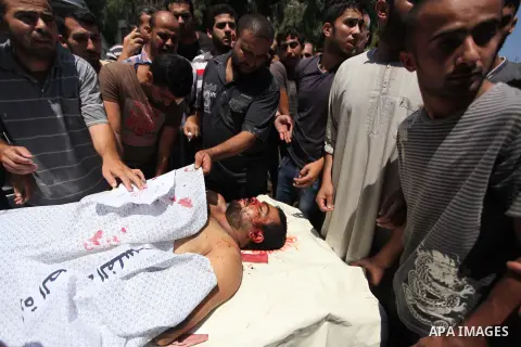 Mourners carry the lifeless body of Palestinian Mahmoud Habib, 27, killed on the sixteenth day of the war in Gaza, to a mosque in Gaza City, Wednesday, July 23, 2014. Offering the first glimmer of hope for a Gaza cease-f...