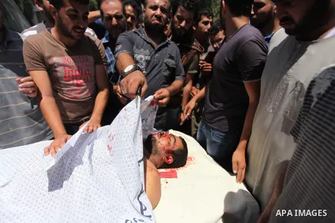 Mourners carry the lifeless body of Palestinian Mahmoud Habib, 27, killed on the sixteenth day of the war in Gaza, to a mosque in Gaza City, Wednesday, July 23, 2014. Offering the first glimmer of hope for a Gaza cease-f...