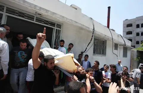 Mourners carry the lifeless body of Palestinian Mahmoud Habib, 27, killed on the sixteenth day of the war in Gaza, to a mosque in Gaza City, Wednesday, July 23, 2014. Offering the first glimmer of hope for a Gaza cease-f...