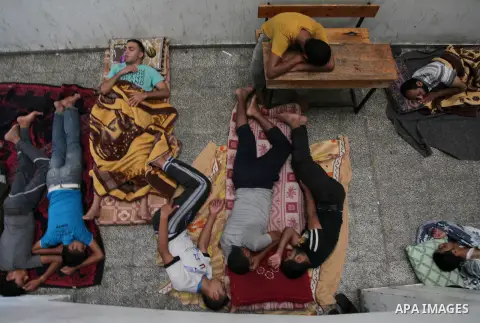 Displaced Palestinians sleep on the ground on July 23, 2014 at a UN school in the refugee camp of Jabalia where families fleeing heavy fighting in the besieged Palestinian territory have taken refuge. A United Nations sc...