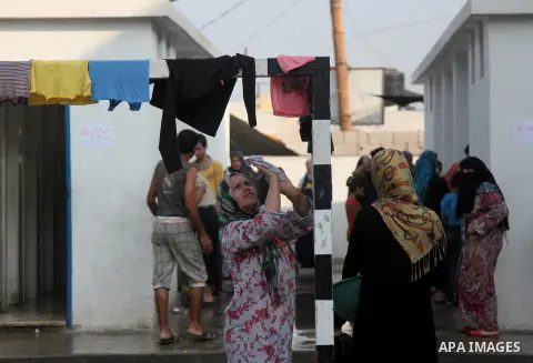 Displaced Palestinians from Beit Hanun in the northern Gaza Strip gather on July 23, 2014 at a UN school in the refugee camp of Jabalia where families fleeing heavy fighting in the besieged Palestinian territory have tak...