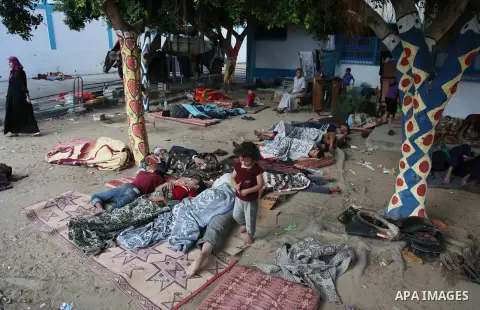 Displaced Palestinians sleep on the ground on July 23, 2014 at a UN school in the refugee camp of Jabalia where families fleeing heavy fighting in the besieged Palestinian territory have taken refuge. A United Nations sc...
