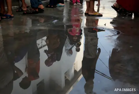 Displaced Palestinian children from Beit Hanun in the northern Gaza Strip gather on July 23, 2014 at a UN school in the refugee camp of Jabalia where families fleeing heavy fighting in the besieged Palestinian territory...
